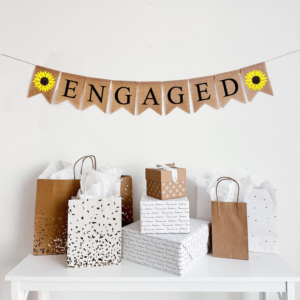 Engaged burlap banner with black letters with vibrant hand stenciled sunflowers on either end. A rustic engagement party banner or engagement announcement banner.