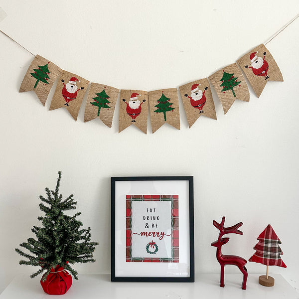 A burlap banner with alternating Christmass trees & Santa Claus painted onto 4x6in fishtail flags.