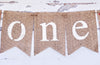burlap banners with the word "one" written on them.