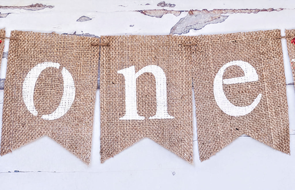 burlap banners with the word "one" written on them.