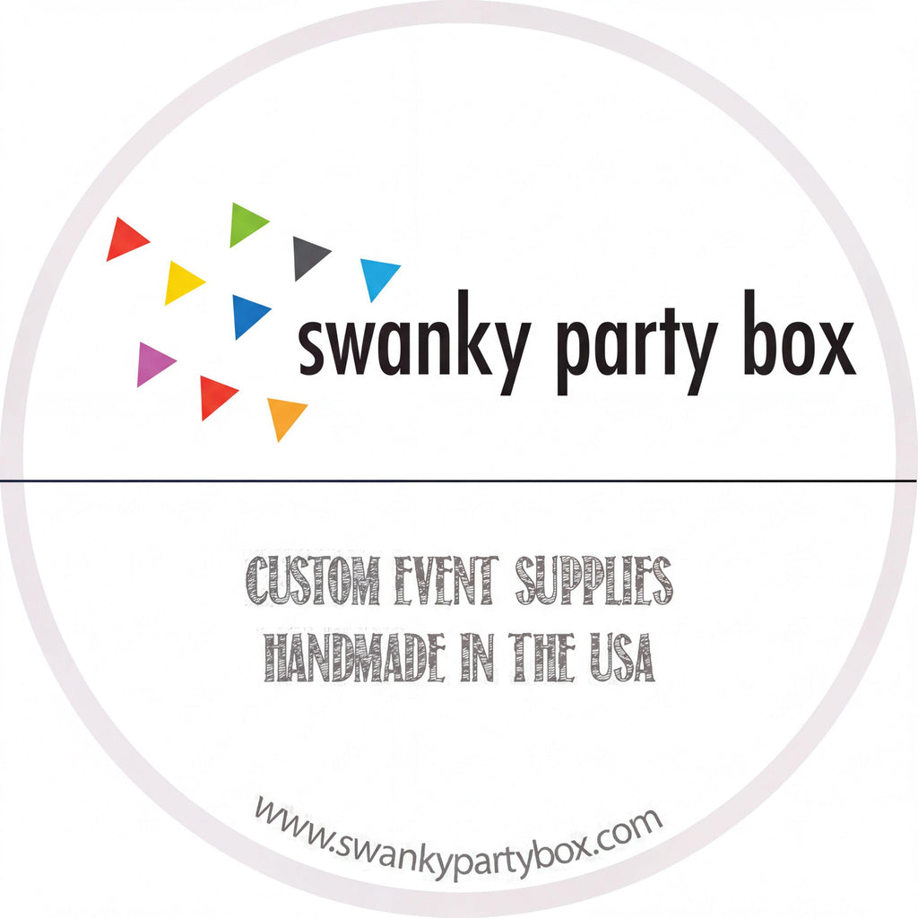 The image is a circular logo for a company called "swanky party box". The logo features a colorful design of triangles in various colors, and the company name is written in bold black text. Below the logo, the company's slogan "CUSTOM EVENT SUPPLIES HANDMADE IN THE USA" is written in a smaller font. The website "www.swankypartybox.com" is also included in the image.