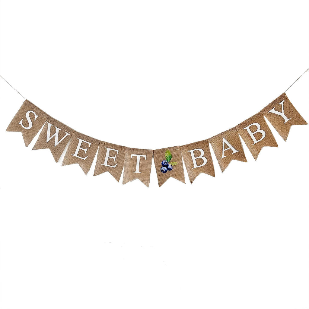 A banner with the word "SWEET BABY" written on it, with a small blueberry decoration placed in the center.