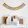 a banner with the word "SWEET ONE" with an image of a lemon between the words, hanging above a table with gifts