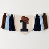 A banner with a cowboy hat and the number 1 printed on it, hanging on a white wall.