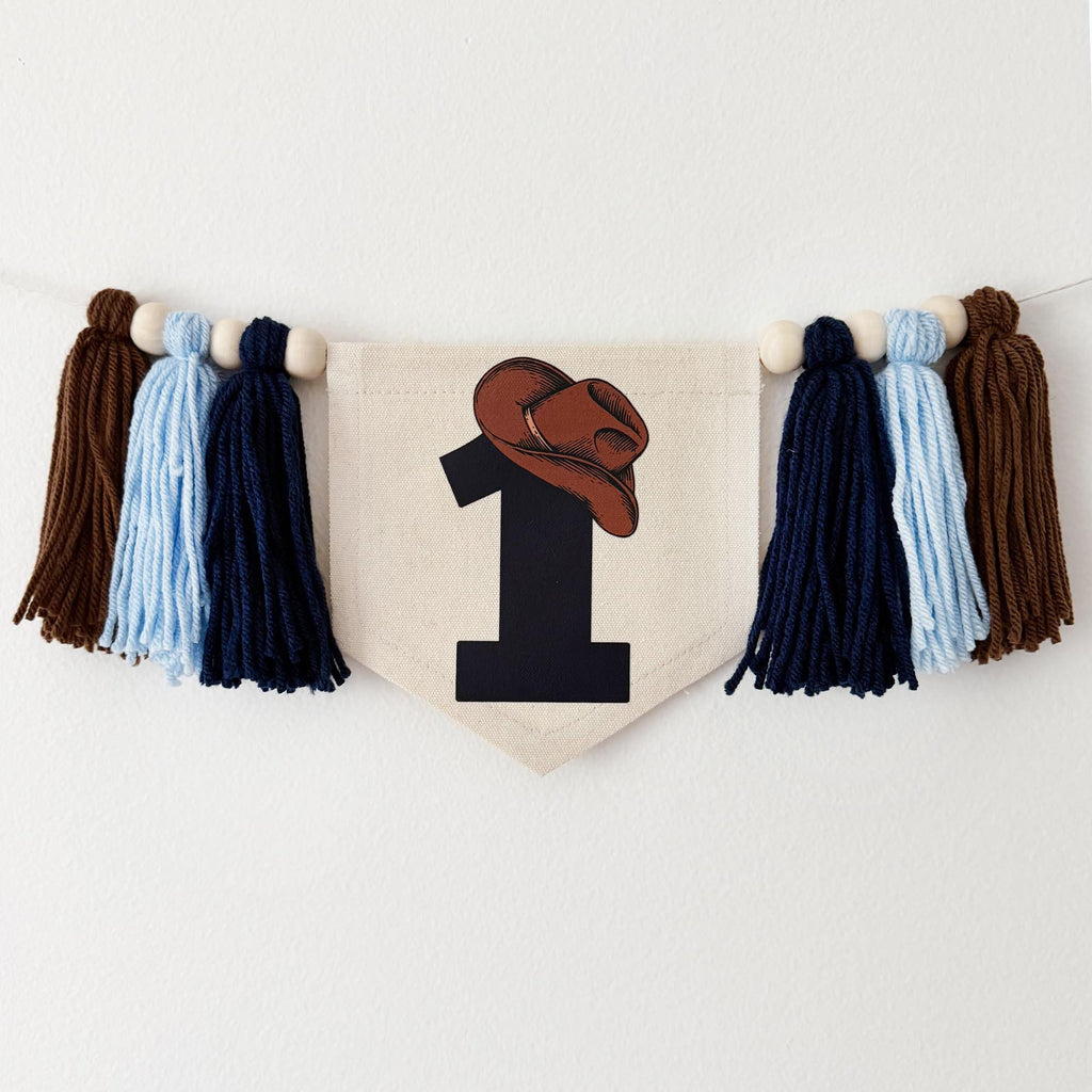 A banner with a cowboy hat and the number 1 printed on it, hanging on a white wall.