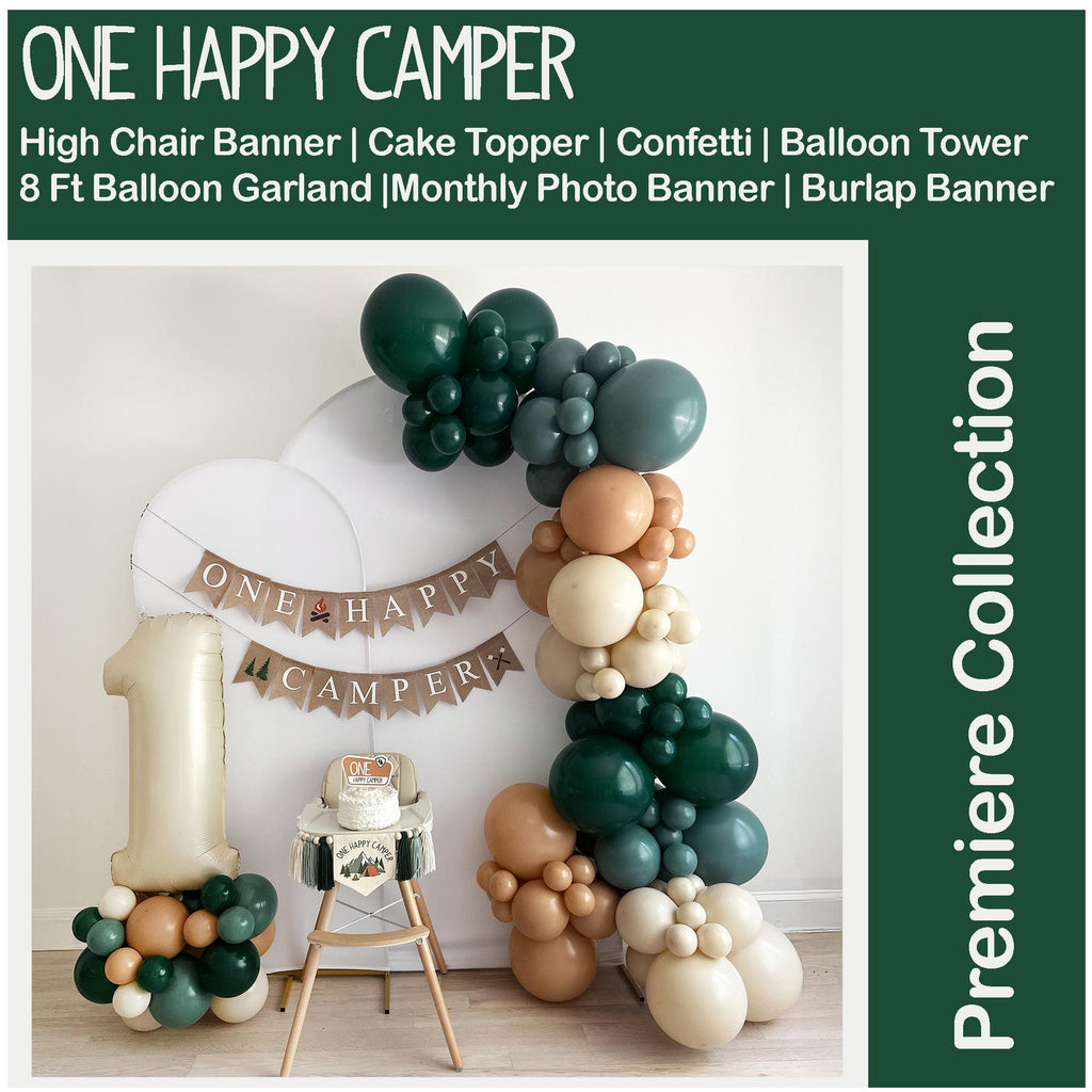 a birthday party with balloons and a balloon arch