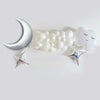 a collection of white balloons and silver stars arranged on a white background.
