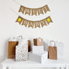 a banner that says "Sweet Baby" with images of yellow lemons around the word Baby, hanging above. a white table with various gift bags