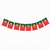 A row of seven small flags, each featuring a red and green color scheme and a circular emblem, hanging against a white background.
