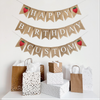 A happy birthday burlap banner strung on two or three strings. The happy is at the top and the birthday below.  Hand painted strawberries are at the beginning and end of the word happy.  The strawberries are painted in red with a green stem and black seeds. This banner has the option to add a third line with a custom name or saying with two additional strawberry image flags.