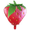 A large red balloon in the shape of a strawberry with green leaves and yellow spots.