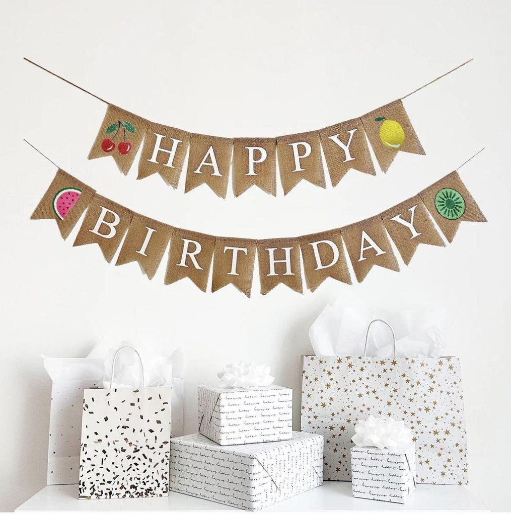 A Happy Birthday burlap banner with fruit themed flags surrounding the words.