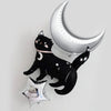a black cat balloon and a silver crescent moon balloon, both adorned with white stars, creating a whimsical and festive atmosphere.
