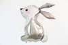 A silver foil balloon in the shape of a rabbit is shown against a white background.