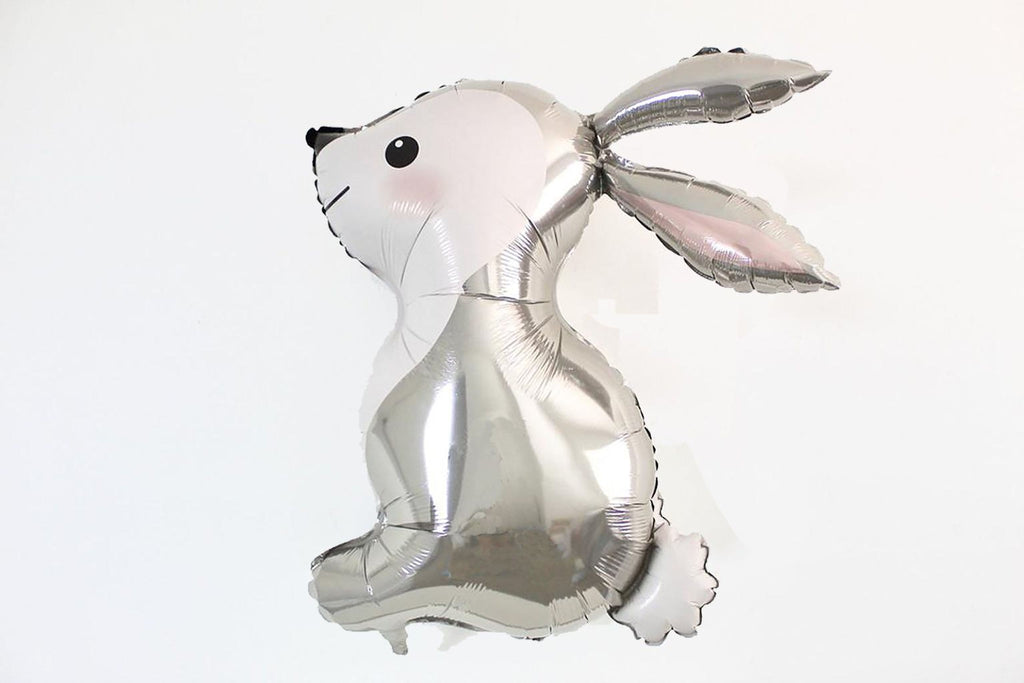 A silver foil balloon in the shape of a rabbit is shown against a white background.