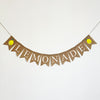 A banner with the word "LEMONADE" written on it, featuring lemon-shaped flags hanging from a string.