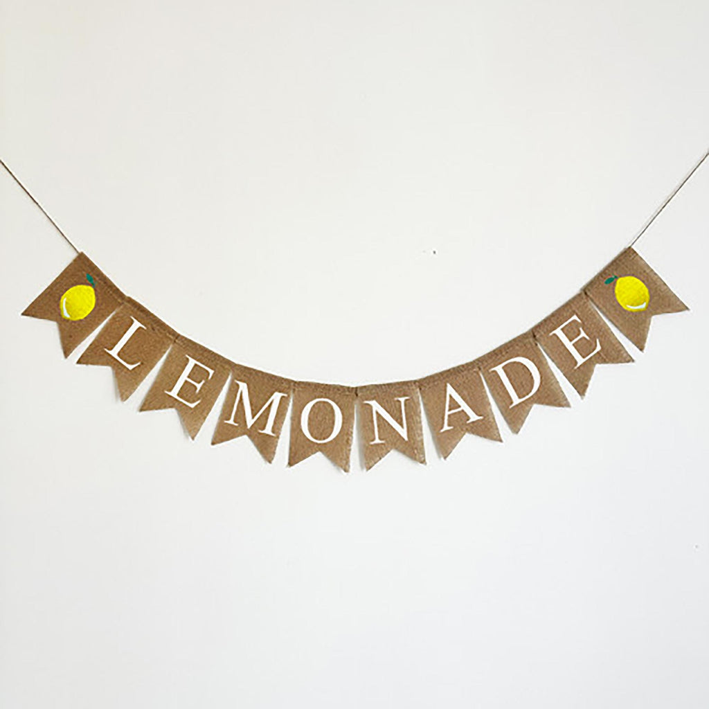 A banner with the word "LEMONADE" written on it, featuring lemon-shaped flags hanging from a string.