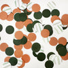 a collection of colorful confetti pieces in various shades of green, orange, and brown, scattered across a white background.