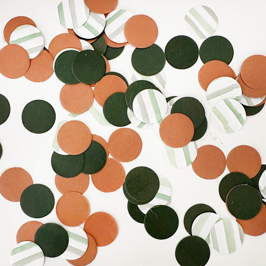 a collection of colorful confetti pieces in various shades of green, orange, and brown, scattered across a white background.