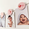 A baby's first year photo banner with a strawberry theme for a 1st birthday party