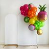A colorful mini balloon garland with different style fruit shaped balloons including watermelon, kiwi, dragonfruit, orange and pineapple.