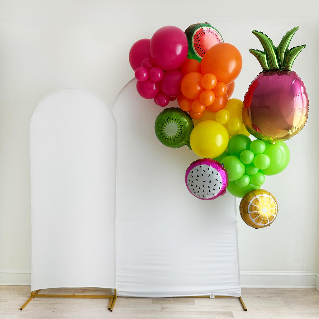 A colorful mini balloon garland with different style fruit shaped balloons including watermelon, kiwi, dragonfruit, orange and pineapple.
