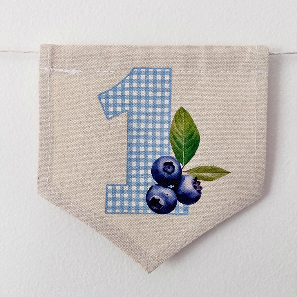 A banner with the number 1 and blueberries printed on it.