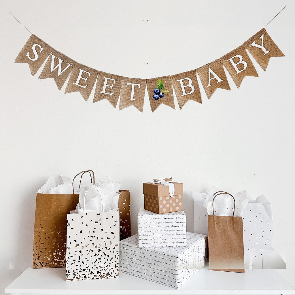 A burlap banner that says "Sweet Baby" with a sweet blueberry accent.