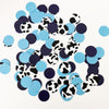 a collection of blue and black confetti pieces scattered across a white background.