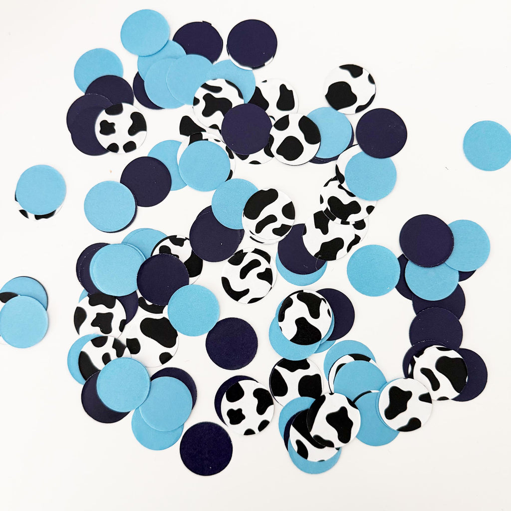 a collection of blue and black confetti pieces scattered across a white background.
