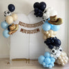 a festive balloon arrangement with a cowboy theme, including balloons in various colors such as blue, white, and black, as well as a banner that reads "a little COWBOY is on the way".