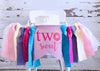 A white high chair decorated with a banner that says "two sweet" and colorful ribbons.