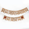 A banner with the text "a little COWBOY is on the way" and two red cowboy hats.