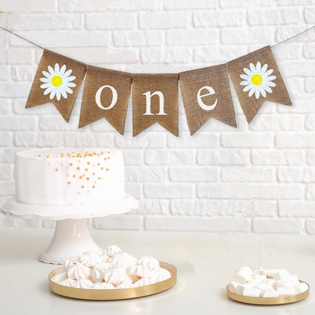Daisy one banner featuring a hand stenciled daisy followed by white letter flags spelling out the word one with another hand stenciled daisy at the end. Perfect for a retro daisy first birthday party or a boho 1st birthday celebration.