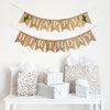 A happy birthday burlap banner strung on two strings. The happy is at the top and the birthday below.  Hand painted cacti with blue flowers are at the beginning and end of the word happy.  The cacti are painted in green with blue flowers.