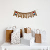 A burlap banner that reads O N E with a red white and blue popsicle on each end. Perfect for a 4th of July First Birthday celebration.