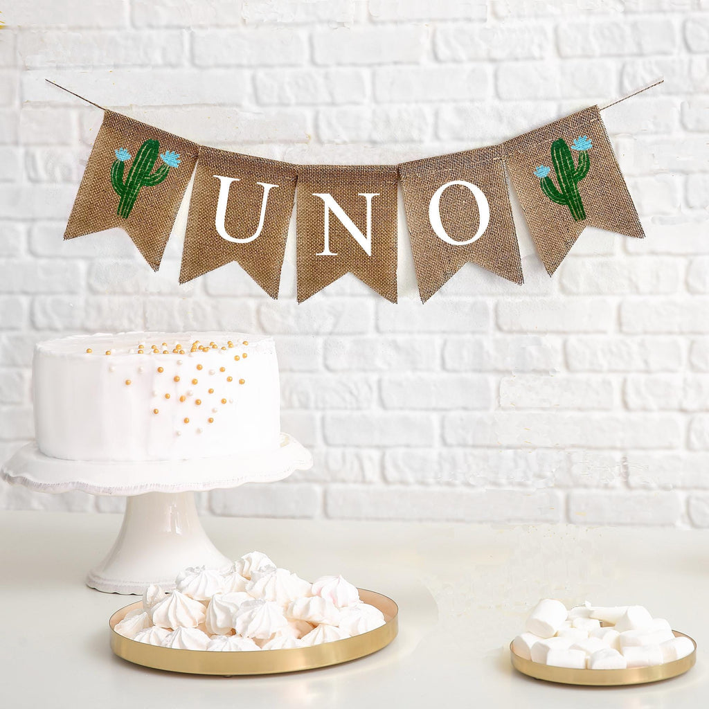 Uno first birthday burlap banner. The banner starts with a cactus flag with blue flowers followed by flags spelling out the word UNO with one more green cactus with blue flowers at the end.