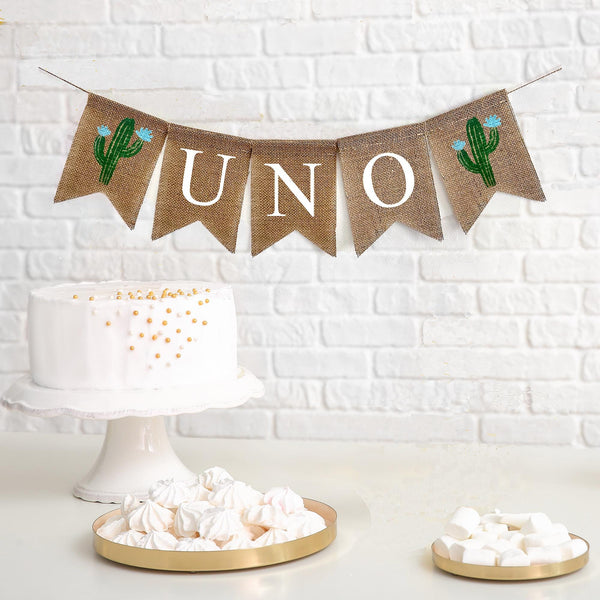 Uno first birthday burlap banner. The banner starts with a cactus flag with blue flowers followed by flags spelling out the word UNO with one more green cactus with blue flowers at the end.