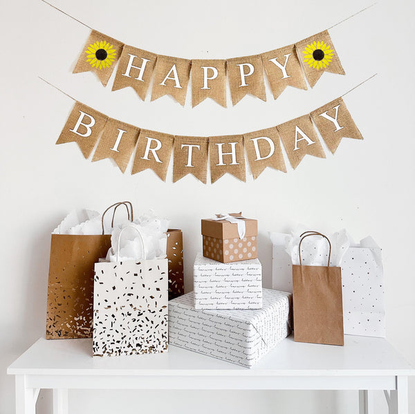 Sunflower themed Happy Birthday burlap banner with white letters and two vibrant yellow hand stenciled sunflowers.