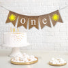 A burlap banner that reads one with yellow sunshine images on each end.