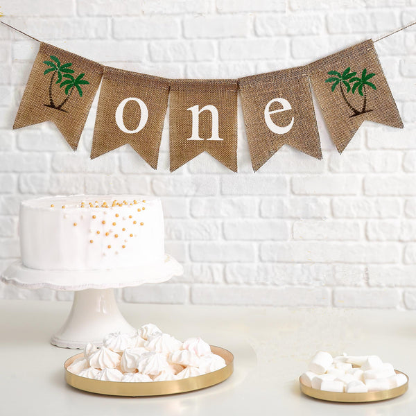 First Birthday Burlap Banner. With palm trees on either end of the banner, the letters spell out o n e in white on burlap flags.