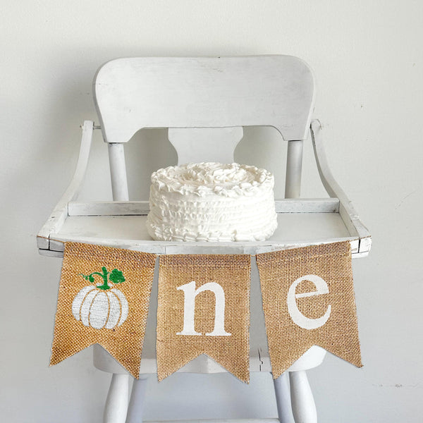Celebrate one with a white pumpkin high chair banner. A rustic white pumpkin as the O followed by an N E banner spelling out ONE. Perfect for a high chair banner or first birthday party backdrop.