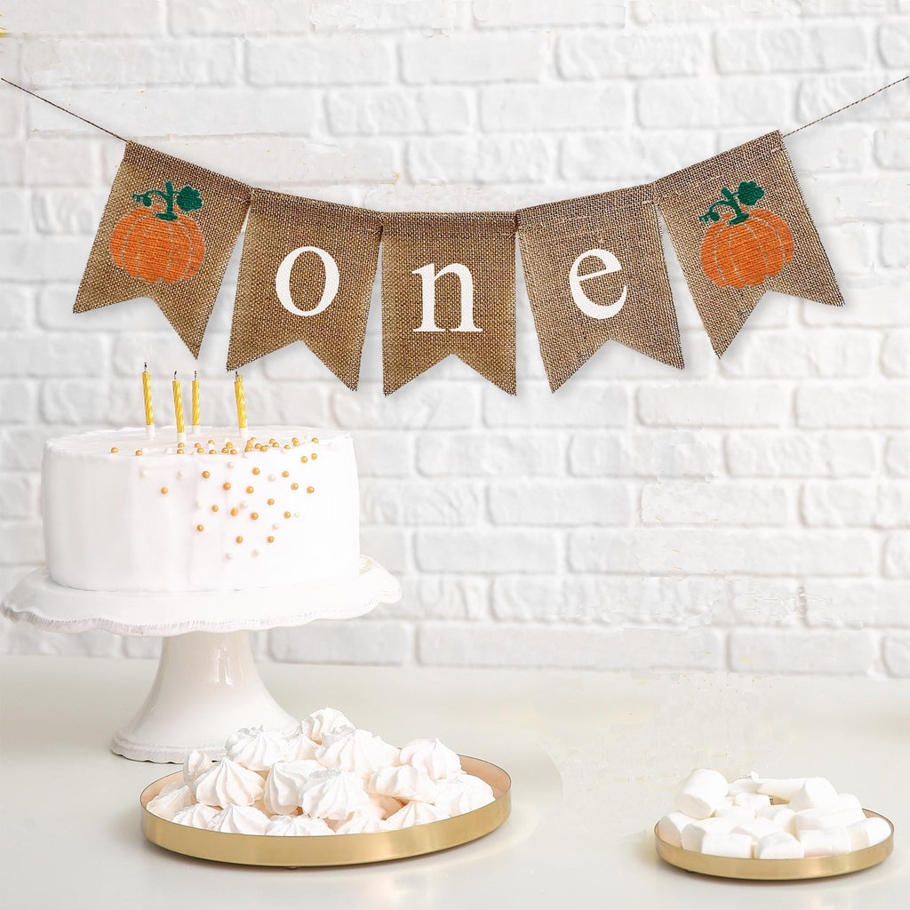 Celebrate one with this orange pumpkin burlap banner. With unique rustic orange pumpkins on each end and the letters o n e spelled out in between in white lowercase letters, this banner is perfect for a fall first birthday celebration.