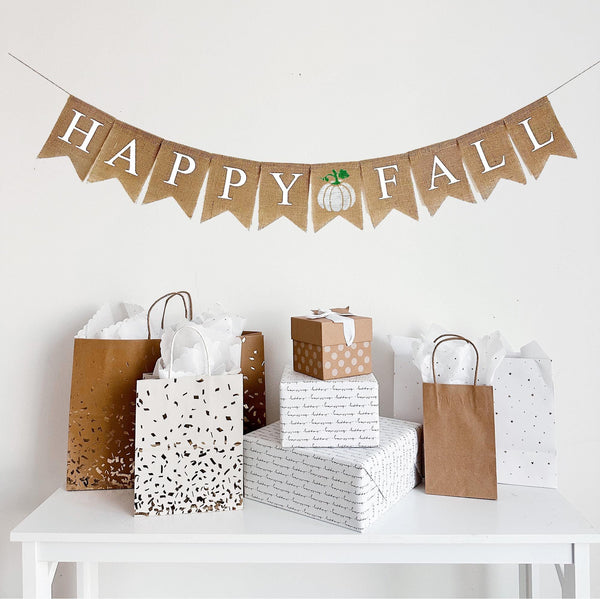 Happy Fall Burlap Banner with a white hand stenciled pumpkin in between the two words. Each flag is 4.5 x 6.5 making this banner perfect for a photo backdrop or fireplace mantel decor.