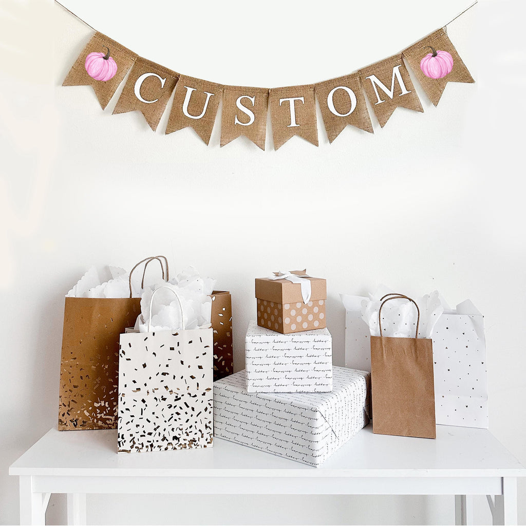 Customize this burlap banner with pink water colored pumpkins. With white letters on top of fishtail burlap flags, this banner is the perfect way to personalize a fall celebration