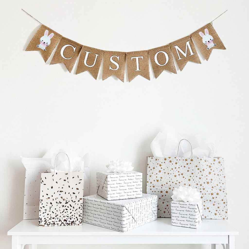 Custom burlap banner featuring two cute hand stenciled white bunnies on each end. This banner can be customized to say a name or any quote or saying that fits in with your decor. It&#39;s perfect for a baby shower, nursery decor or some seasonal decorations.