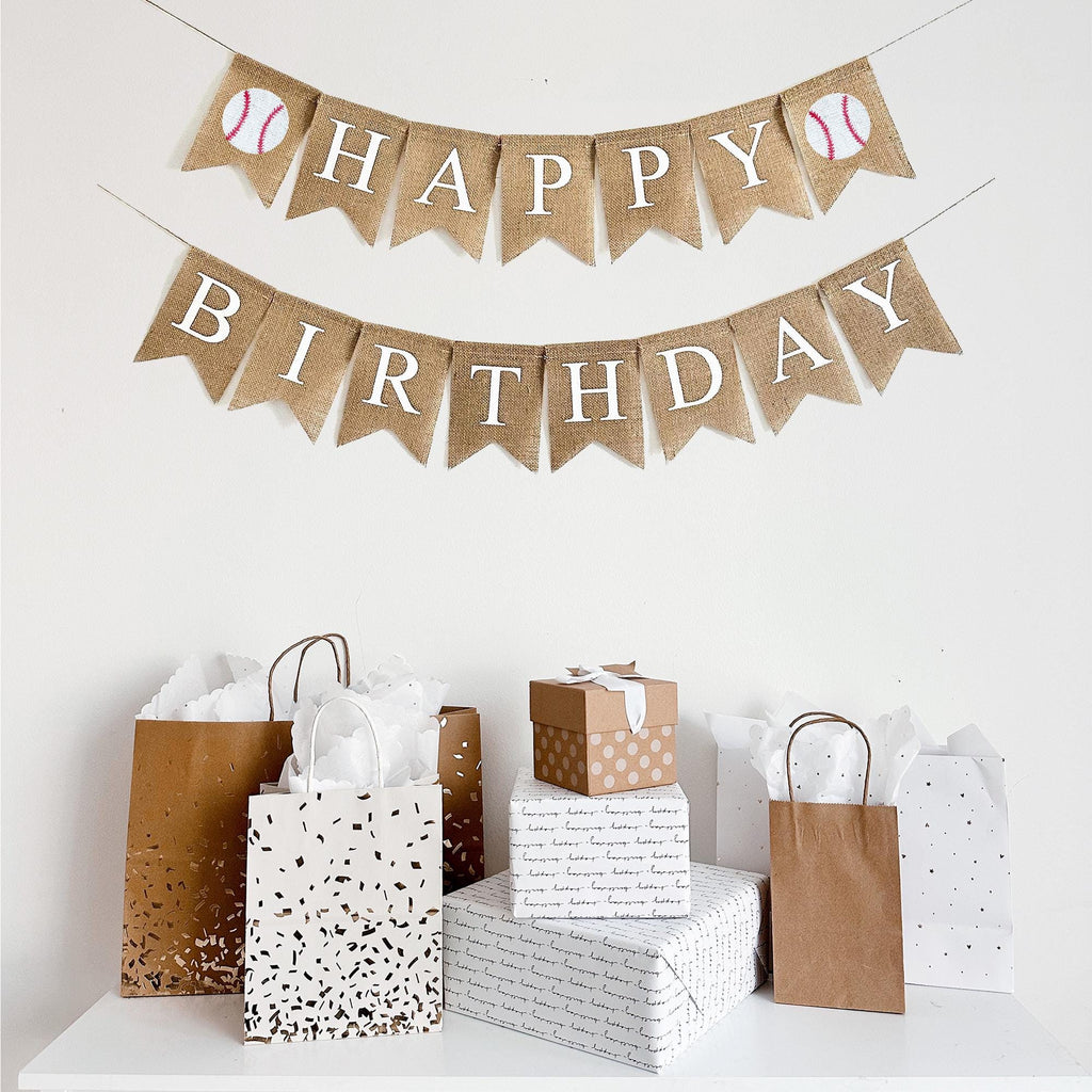 This Happy Birthday burlap banner runs on two lines. The top line starts with a hand stenciled baseball following back fishtail burlap flags spelling out the word happy. At the end of Happy, there is another baseball image. The second line spells out the word Birthday also in white lettering.