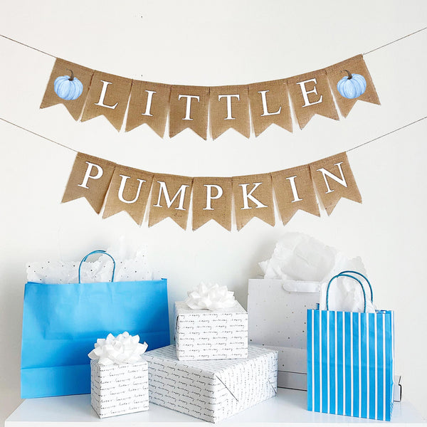 Burlap banner featuring two blue  pumpkins with brown stem. Letter flags spell out the words Little Pumpkin in white letters.