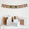 A burlap banner with fishtail flags featuring the words Boy or Girl with a hand stenciled green shamrock in between boy and or and then another between or and girl. The letters are bright white over a beige flag, the clovers are 3 leaf clovers. This banner is perfect for a gender reveal or baby shower with a St. Patrick&#39;s Day theme.