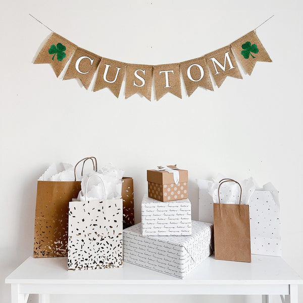 This customizable burlap banner contains 2 green shamrock flags and white lettered flags, customizable to spell out any word or saying for your event. Add some rustic charm to your party decor with this customizable burlap banner.